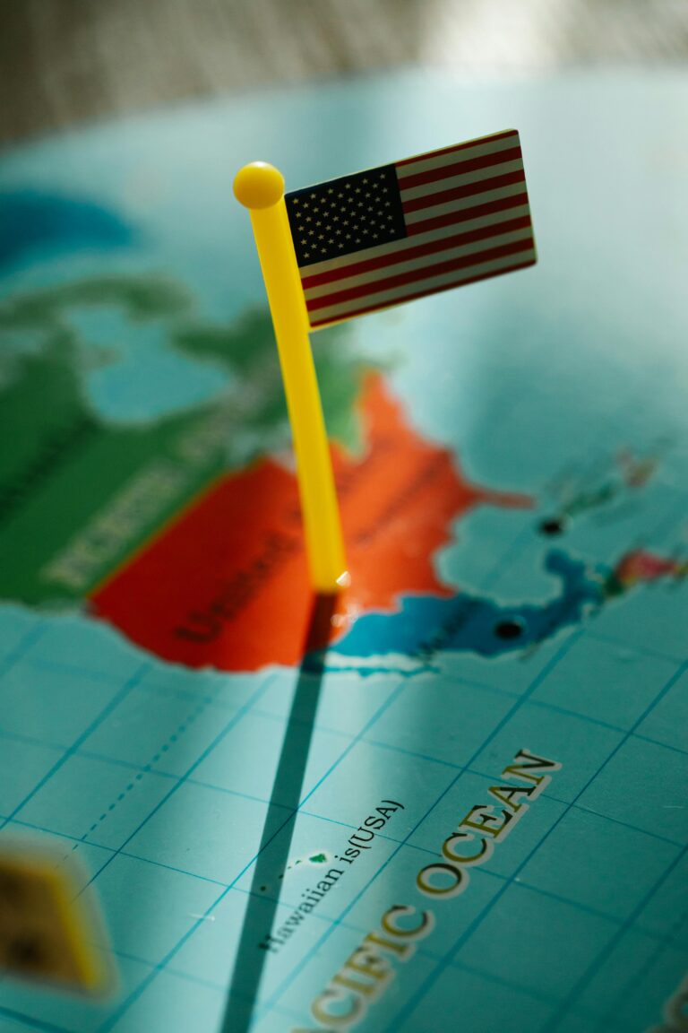 Close-up of a USA flag pin on a North American map, showcasing geography.
